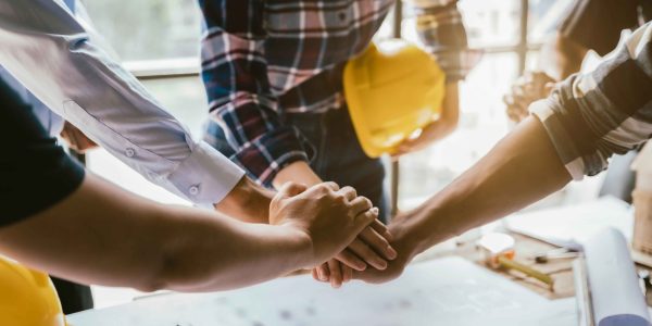 construction worker and contractor. Client shaking hands with team builder in renovation site in the morning.